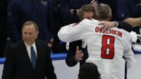 Former Canadian-American ice hockey player Wayne Gretzky (middle) and Commissioner of the NHL Gary Bettman congratulates Washington Capitals left wing Alex Ovechkin (8) after scoring a goal in the 2nd period against the New York Islanders at UBS Arena. The goal is the 895th of Ovechkin’s career, breaking the NHL all-time career goals record previously held by Wayne Gretzky.at UBS Arena