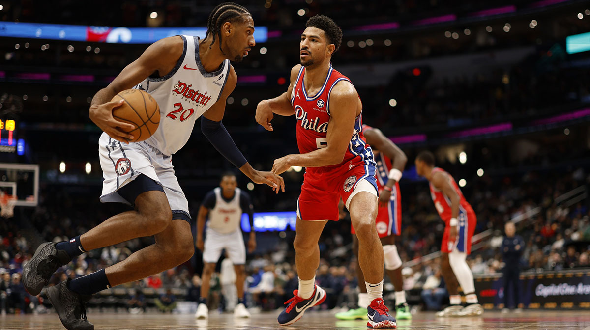 Washington Wizards forward Alex Sarr (20) dribbles the ball as Philadelphia 76ers guard Quentin Grimes (5) defends in the second half at Capital One Arena.
