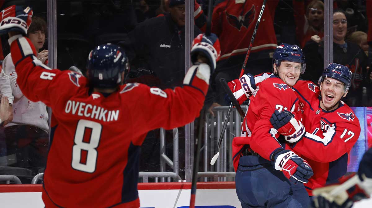 Washington Capitals center Aliaksei Protas (21) celebrates with Capitals center Dylan Strome (17) and Capitals left wing Alex Ovechkin (8) after scoring a goal against the Columbus Blue Jackets in the first period at Capital One Arena.