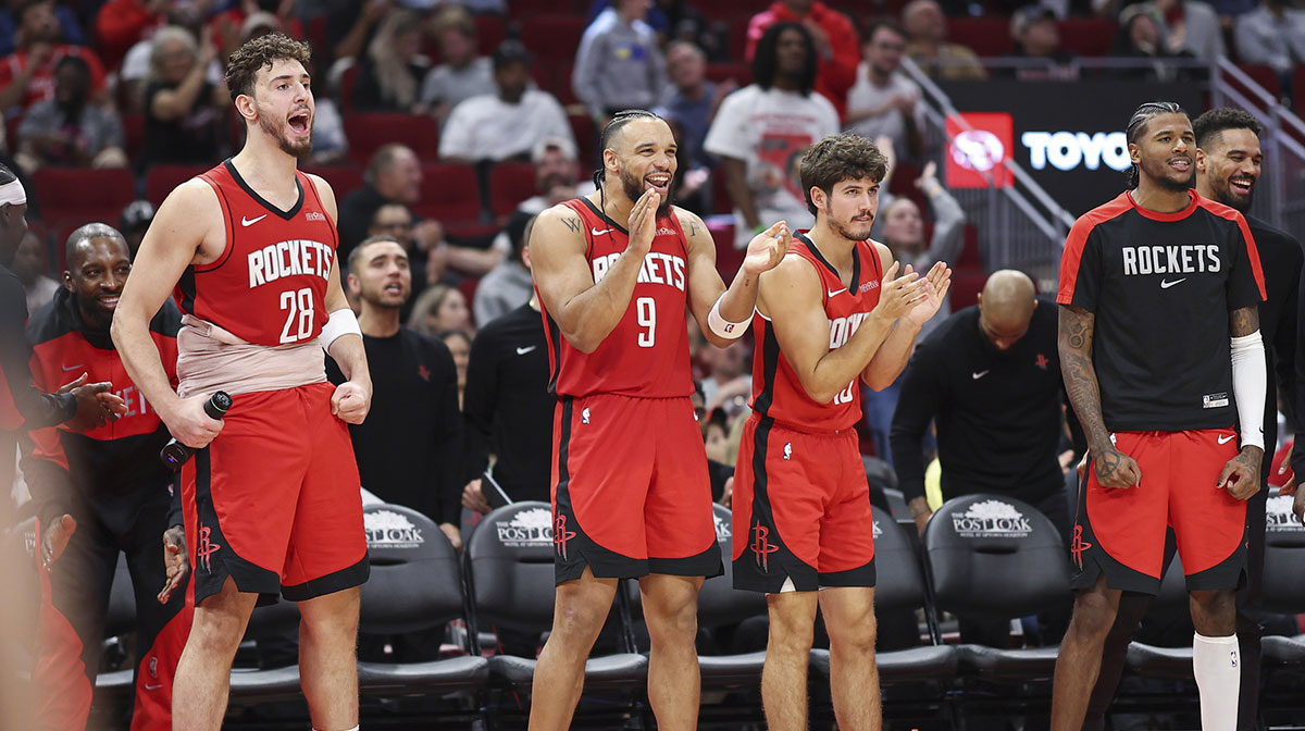 Houston Rockets center Alperen Sengun (28) and forward Dillon Brooks (9) and guard Reed Sheppard (15) and guard Jalen Green (4) react from the bench after a play during the fourth quarter against the Memphis Grizzlies at Toyota Center.