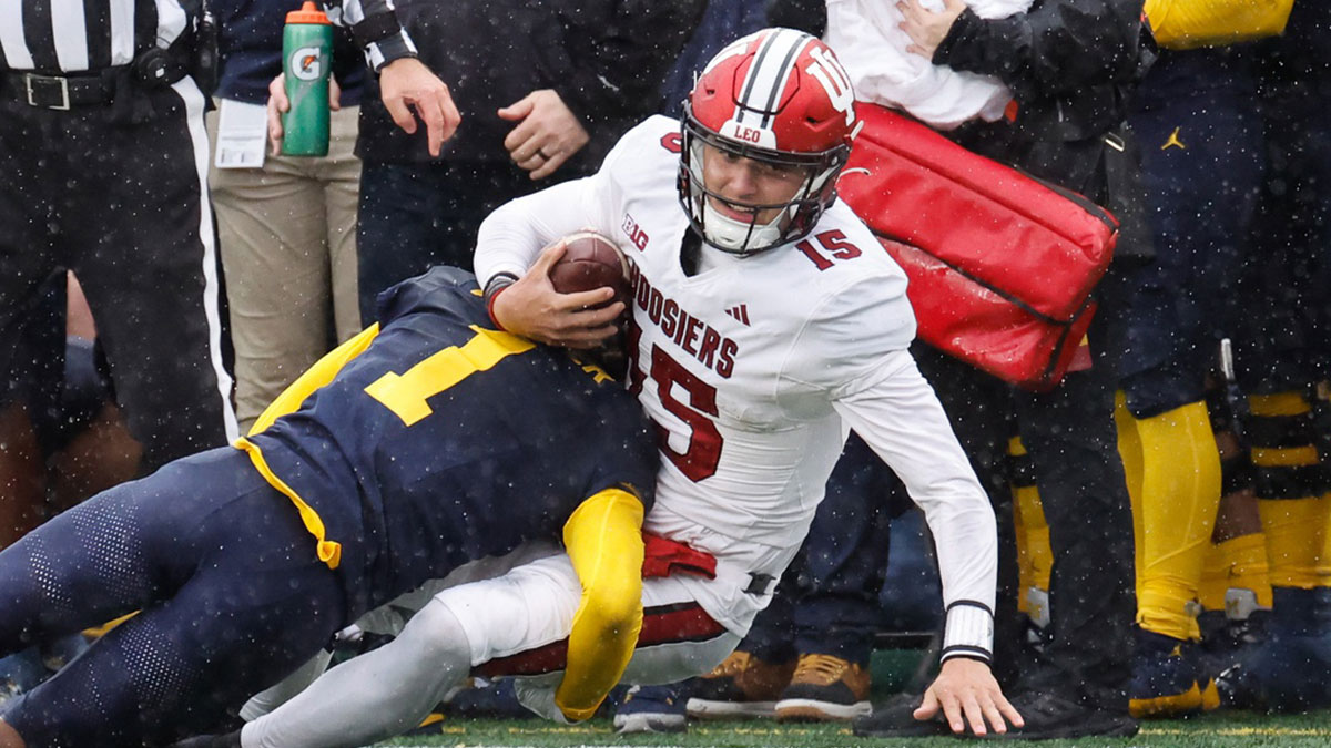 Indiana Hoosiers quarterback Brendan Sorsby (15) is tackled by Michigan Wolverines defensive back Amorion Walker (1) in the second half at Michigan Stadium. Mandatory Credit: Rick Osentoski-Imagn Images