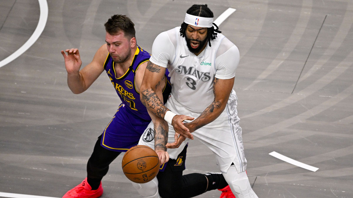 Los Angeles Lakers guard Luka Doncic (77) knocks the ball away from Dallas Mavericks forward Anthony Davis (3) during the first quarter at the American Airlines Center.