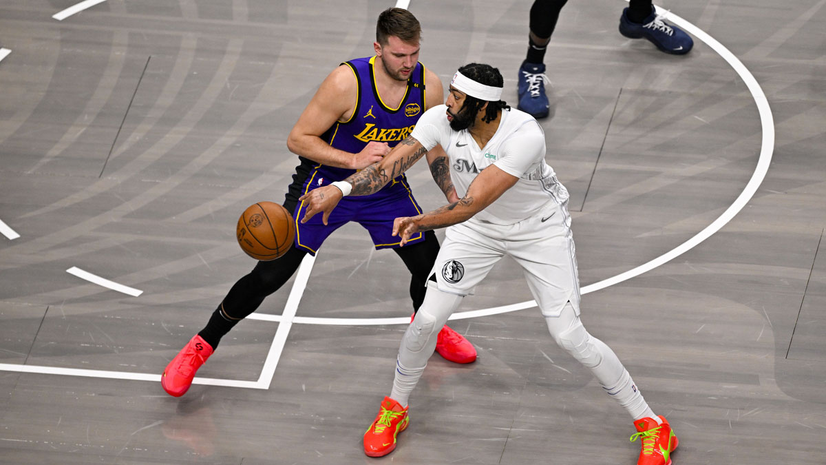 Dallas Mavericks forward Anthony Davis (3) looks to pass the ball by Los Angeles Lakers guard Luka Doncic (77) during the first quarter at the American Airlines Center.