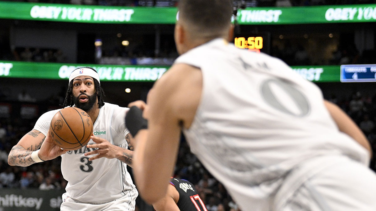 Dallas Mavericks forward Anthony Davis (3) passes the ball to Dallas Mavericks guard Dante Exum (0) during the second half at the American Airlines Center.
