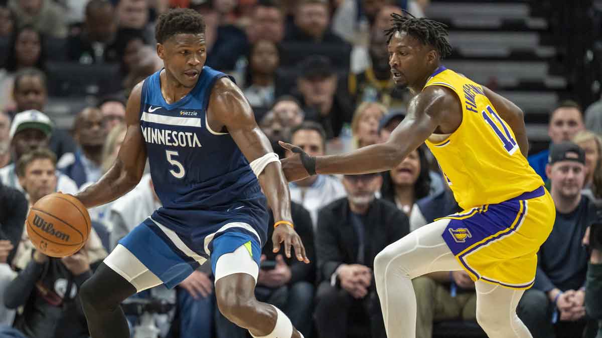 Minnesota Timberwolves guard Anthony Edwards (5) backs towards the basket against the Los Angeles Lakers forward Dorian Finney-Smith (17) in the first half during game three of first round for the 2024 NBA Playoffs at Target Center.