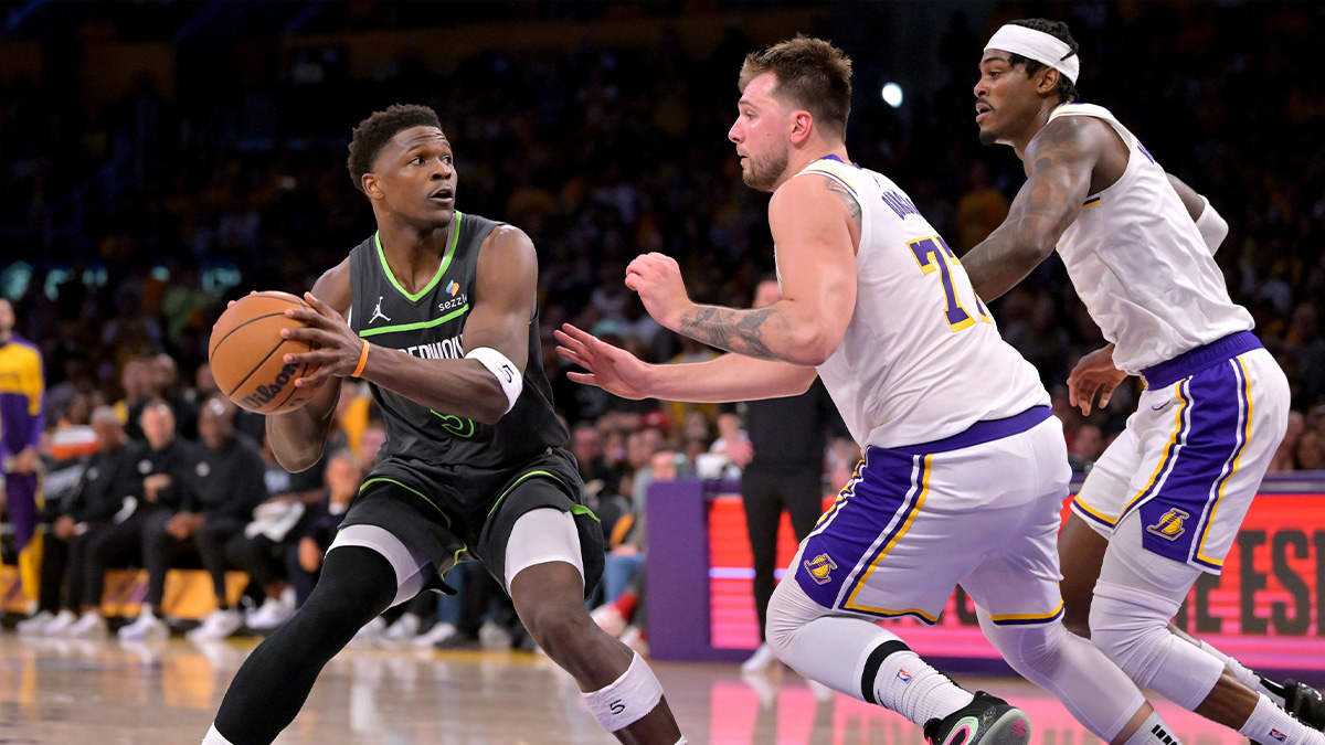 Minnesota Timberwolves guard Anthony Edwards (5) is defended by Los Angeles Lakers guard Luka Doncic (77) in the second half at Crypto.com Arena. Mandatory Credit: Jayne Kamin-Oncea-Imagn Images
