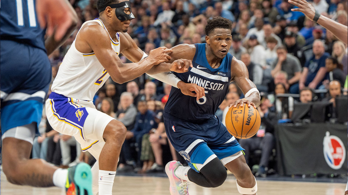 Minnesota Timberwolves guard Anthony Edwards (5) drives to the basket with Los Angeles Lakers forward Rui Hachimura (28) and forward Dorian Finney-Smith (17) on defense in the third quarter during game four of first round for the 2025 NBA Playoffs at Target Center.
