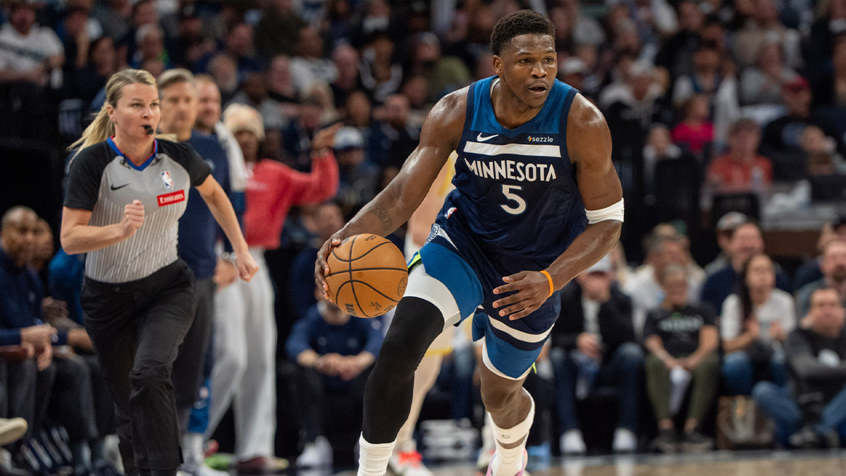 Minnesota Timberwolves guard Anthony Edwards (5) brings the ball up court as Utah Jazz guard Svi Mykhailiuk (19) defends in the first quarter at Target Center.
