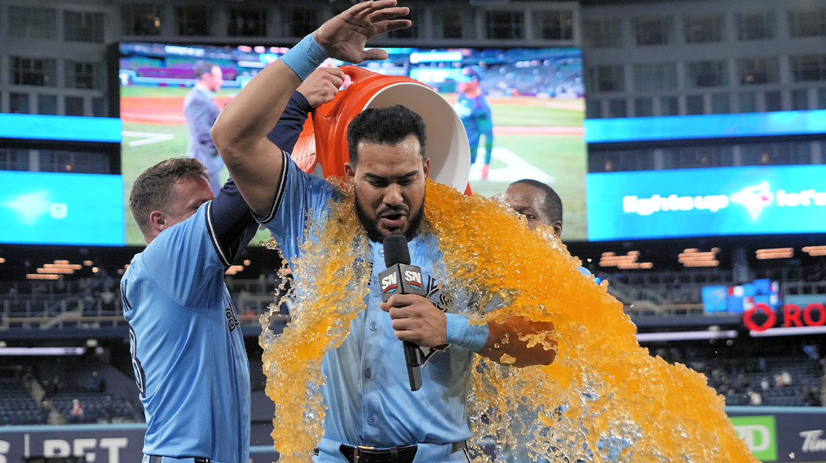 Toronto Blue Jays designated hitter Anthony Santander (25) gets doused with Gatorade following an extra inning win over the Boston Red Sox at Rogers Centre.