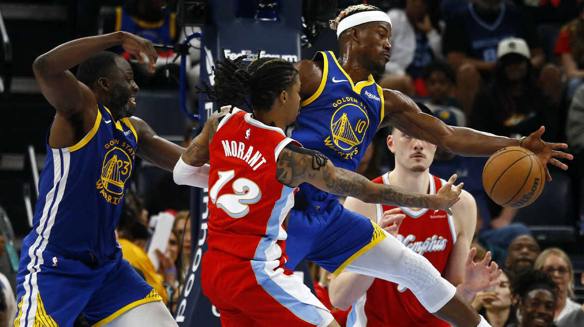 Golden State Warriors forward Draymond Green (23) and forward Jimmy Butler III (10) defend as Memphis Grizzlies guard Ja Morant (12) drives to the basket during the fourth quarter at FedExForum