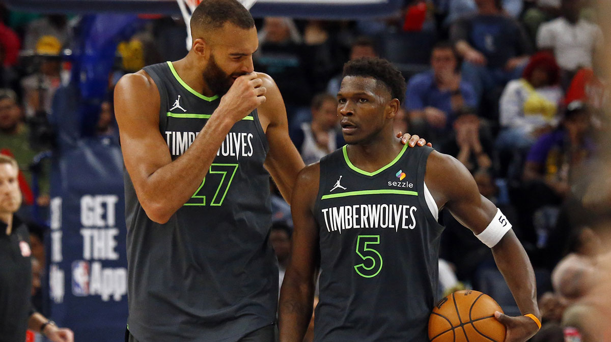 Minnesota Timberwolves center Rudy Gobert (27) talks with guard Anthony Edwards (5) during a time out during the fourth quarter against the Memphis Grizzlies at FedExForum.