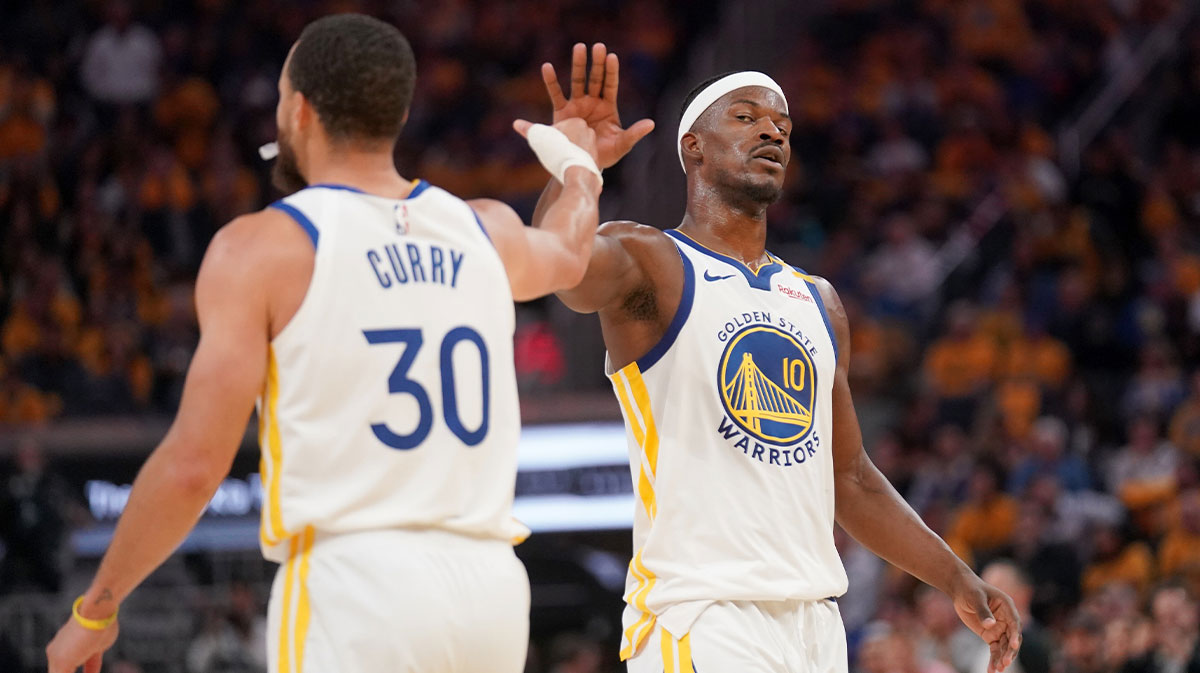 Golden State Warriors forward Jimmy Butler III (10) and guard Stephen Curry (30) meet after a play against the Memphis Grizzlies in the second quarter at the Chase Center.