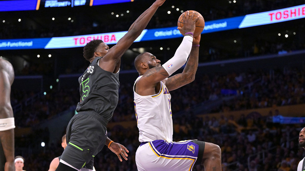 Los Angeles Lakers forward LeBron James (23) is fouled by Minnesota Timberwolves guard Anthony Edwards (5) as he goes up for a basket in the first half at Crypto.com Arena.