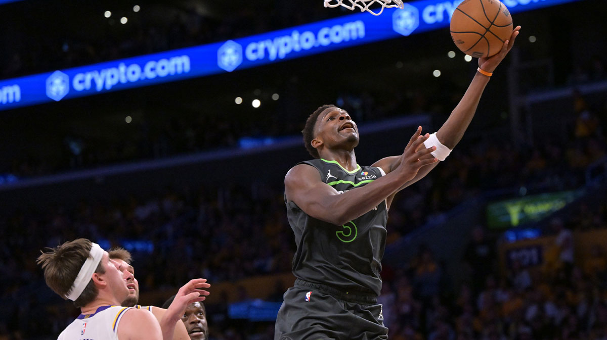 Minnesota Timberwolves guard Anthony Edwards (5) drives past Los Angeles Lakers guard Austin Reaves (15) in the second half at Crypto.com Arena.