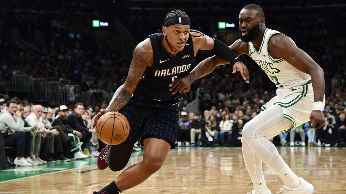 Orlando Magic forward Paolo Banchero (5) controls the ball while Boston Celtics guard Jaylen Brown (7) defends during the first half at TD Garden.