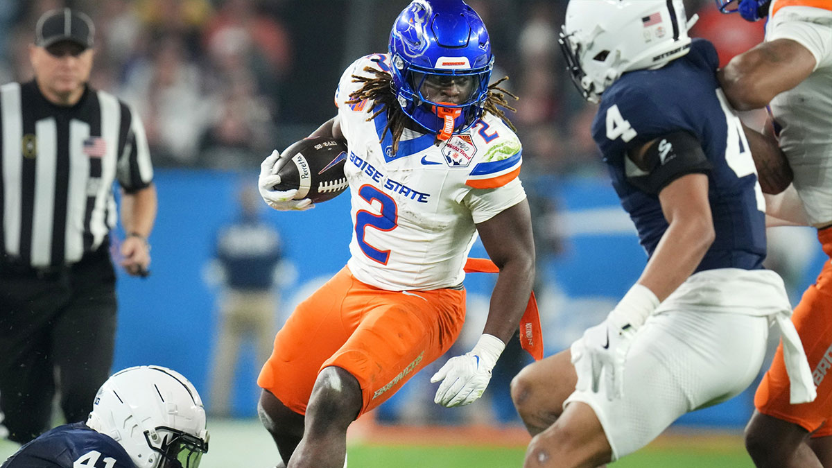 Boise State Broncos running back Ashton Jeanty (2) runs past Penn State Nittany Lions linebacker Kobe King (41) during their Vrbo Fiesta Bowl matchup at State Farm Stadium on Dec. 31, 2024.