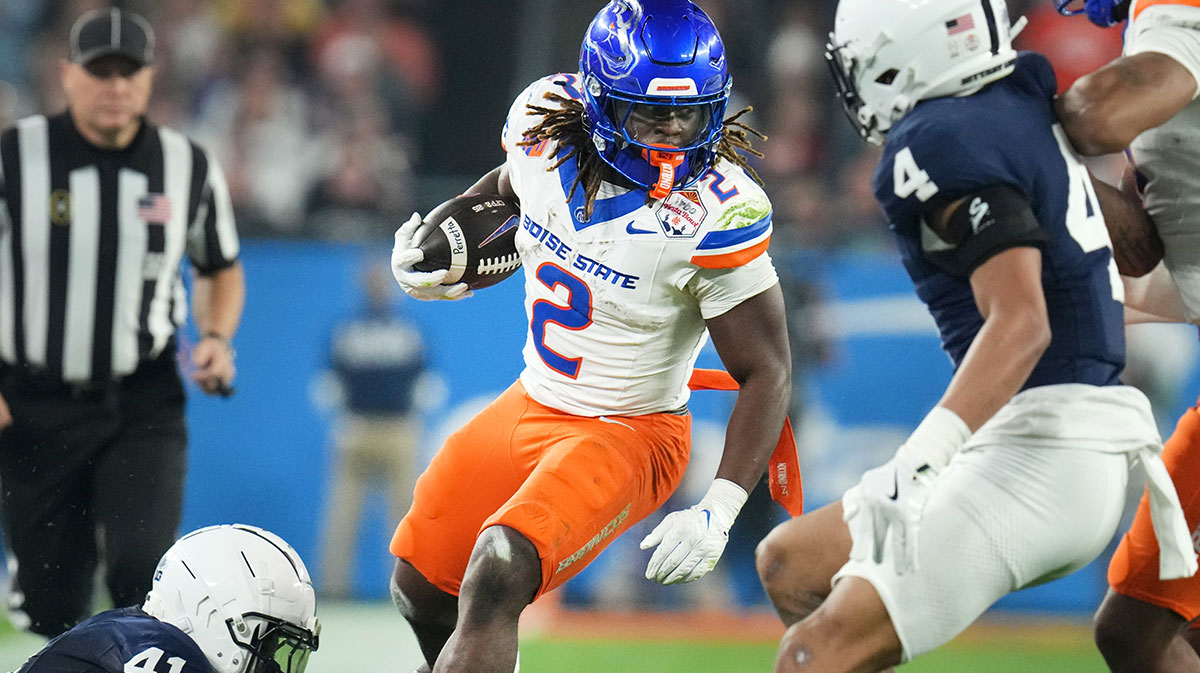 LAS VEGAS RAIDERS: Boise State Broncos running back Ashton Jeanty (2) runs past Penn State Nittany Lions linebacker Kobe King (41) during their Vrbo Fiesta Bowl matchup at State Farm Stadium on Dec. 31, 2024.