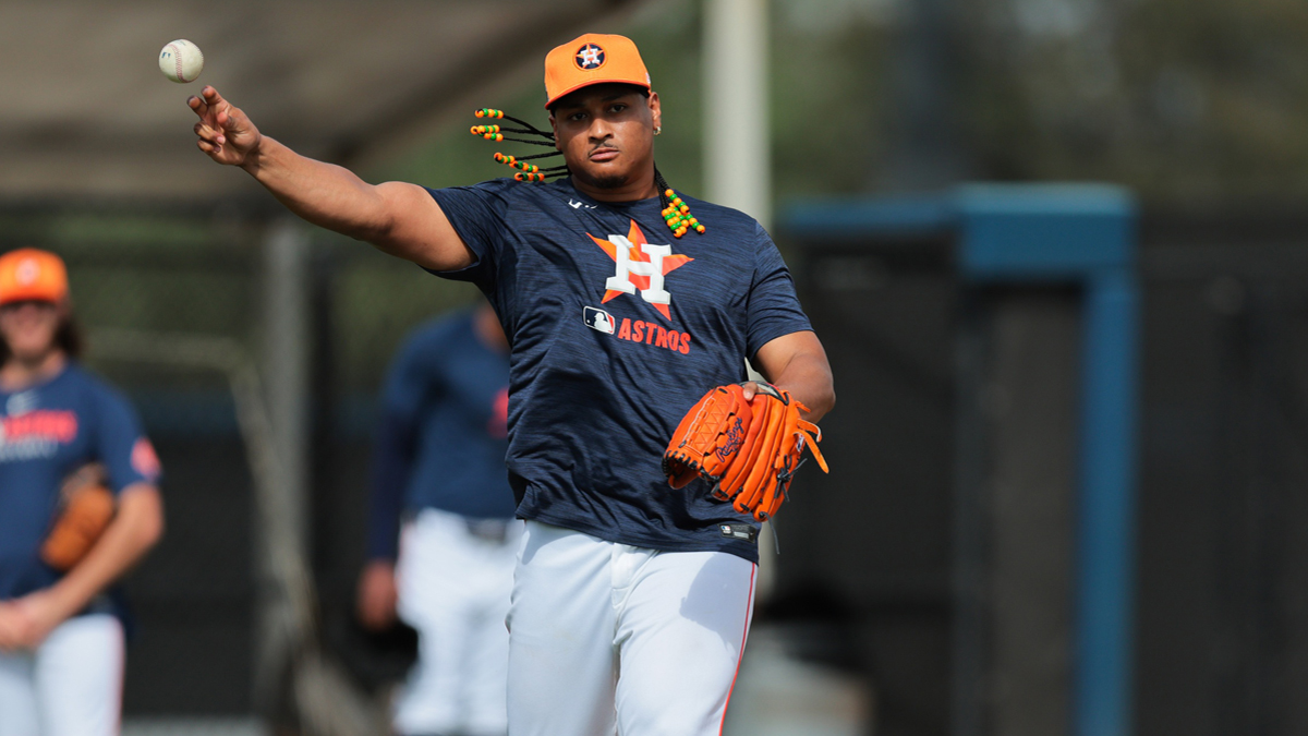 Houston Astros starting pitcher Luis Garcia (77) works on a fielding exercise during a spring training workout at CACTI Park of the Palm Beaches