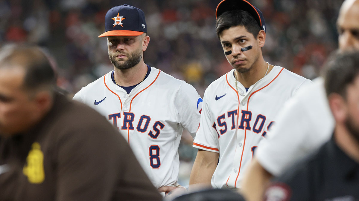 Houston Astros first baseman Christian Walker (8) and second baseman Mauricio Dubon (14) watch as San Diego Padres designated hitter Luis Arraez (4) is carted off the field after he colliding with Houston Astros first baseman Christian Walker (8) in the first base line in the first inning at Daikin Park.