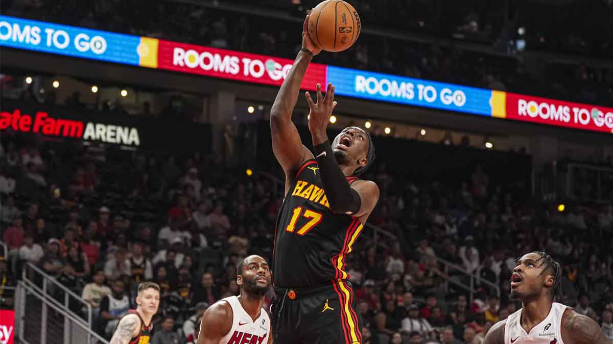 Atlanta striker Hawks Onyeka Okongwu (17) shoots the basket behind the goalkeeper of Miami Heat Davion Mitchell (45) during the first half at State Farm Arena.