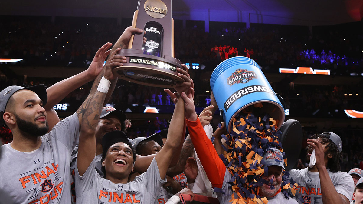 Auburn Tigers forward Johni Broome (4), left, guard Tahaad Pettiford (0) and head coach Bruce Pearl celebrate with teammates after winning the South Regional final of the 2025 NCAA tournament against the Michigan State Spartans at State Farm Arena.