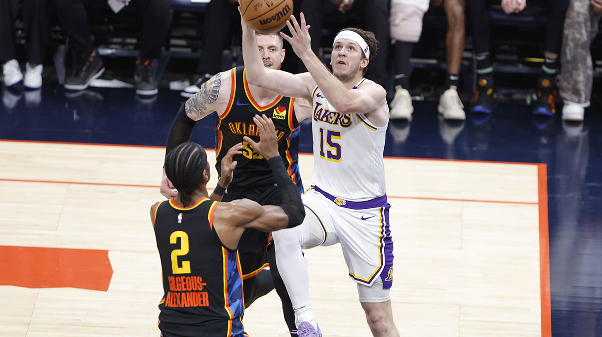 Los Angeles Lakers guard Austin Reaves (15) goes to the basket between Oklahoma City Thunder guard Shai Gilgeous-Alexander (2) and center Isaiah Hartenstein (55) during the second half at Paycom Center.