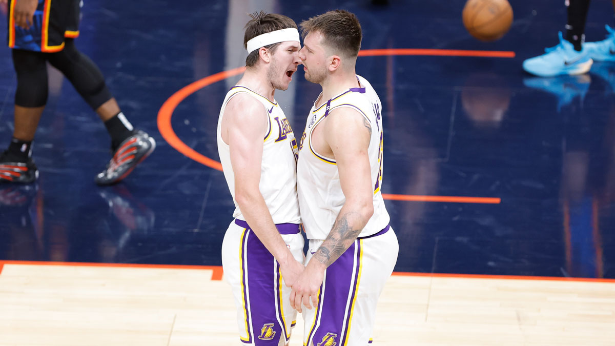 Los Angeles Lakers guard Austin Reaves (15) and guard Luka Doncic (77) celebrate after scoring against the Oklahoma City Thunder during the second half at Paycom Center.