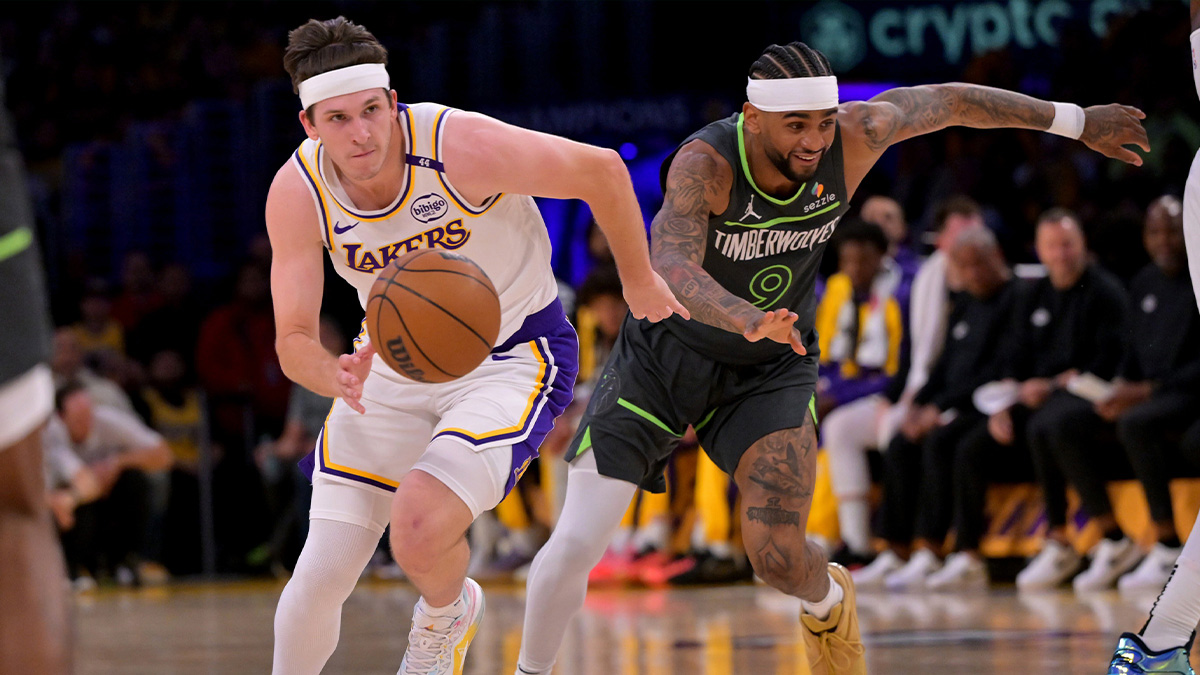Los Angeles Lakers guard Austin Reaves (15) drives past Minnesota Timberwolves guard Nickeil Alexander-Walker (9) in the first half at Crypto.com Arena.