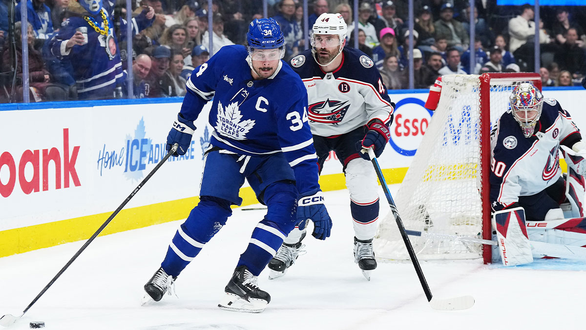 Toronto Maple Leafs center Auston Matthews (34) battles for the puck with Columbus Blue Jackets defenseman Erik Gudbranson (44) during the third period at Scotiabank Arena. 
