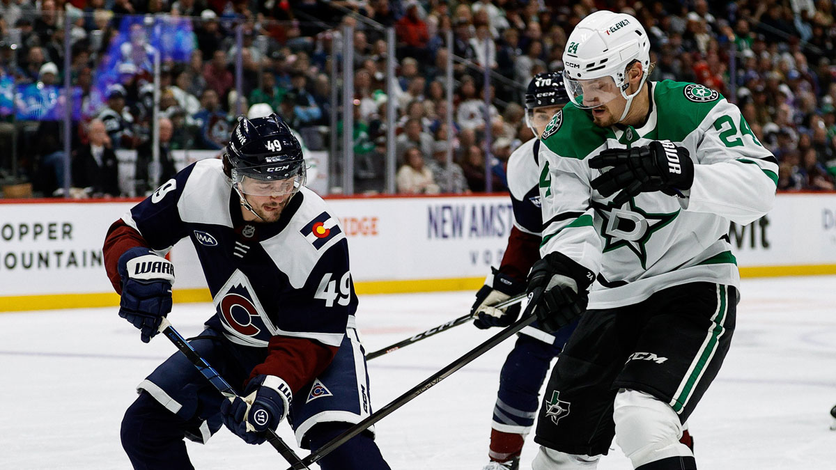 Colorado Avalanche defenseman Samuel Girard (49) and Dallas Stars center Roope Hintz (24) battle for the puck in the first period at Ball Arena.