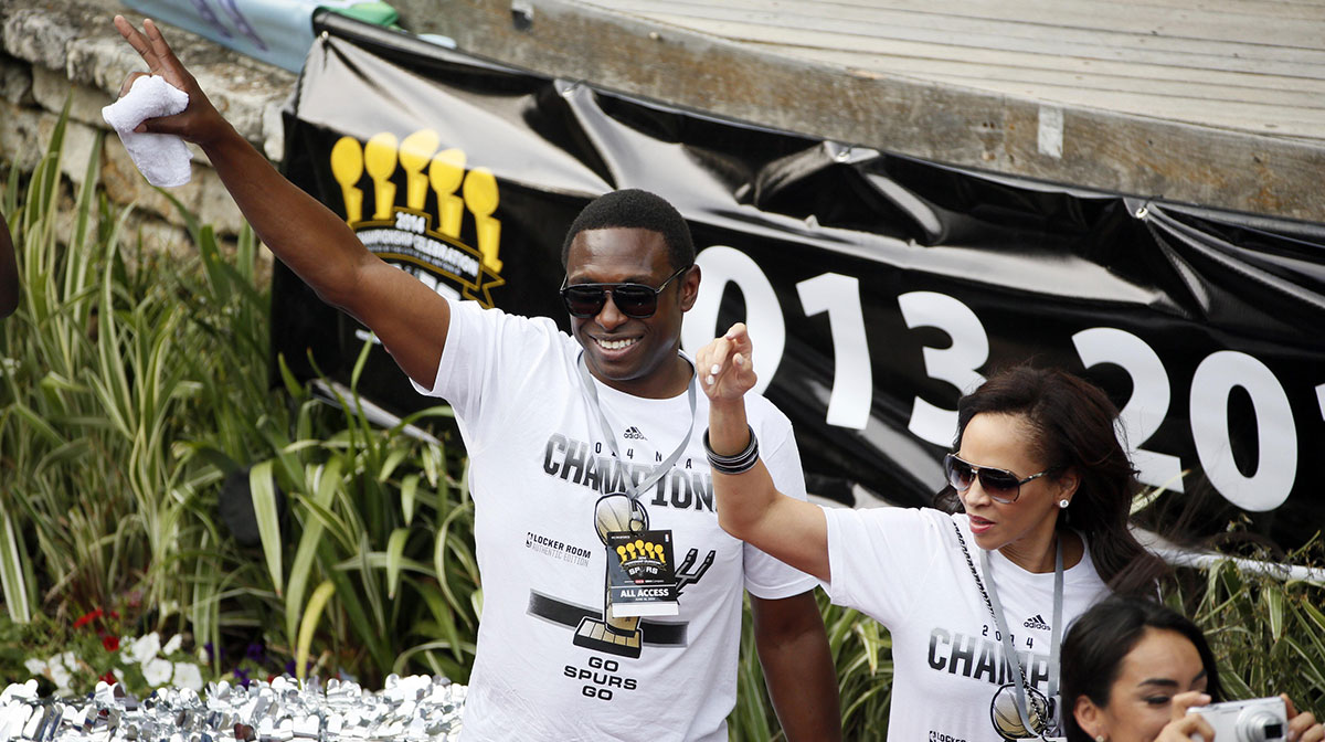 San Antonio Spurs former guard Avery Johnson waves to the fans during the NBA championship parade at San Antonio River Walk.