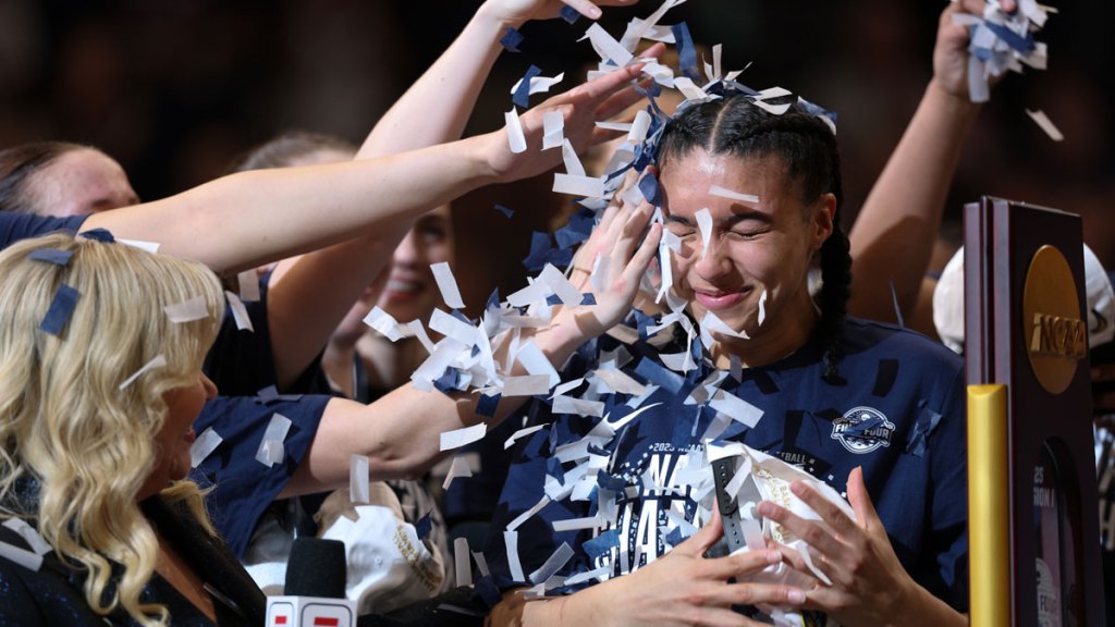Connecticut Huskies guard Azzi Fudd (35) gets confettied by her teammates while interviewed by ESPN reporter Holly Rowe after the national championship of the women's 2025 NCAA tournament against the South Carolina Gamecocks.