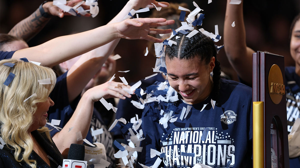 Connecticut Huskies guard Azzi Fudd (35) gets confettied by her teammates while interviewed by ESPN reporter Holly Rowe after the national championship of the women's 2025 NCAA tournament against the South Carolina Gamecocks at Amalie Arena