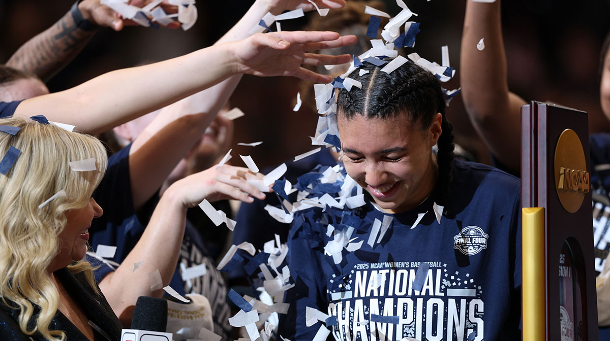 Connecticut Huskies guard Azzi Fudd (35) gets confettied by her teammates while interviewed by ESPN reporter Holly Rowe after the national championship of the women's 2025 NCAA tournament against the South Carolina Gamecocks at Amalie Arena.