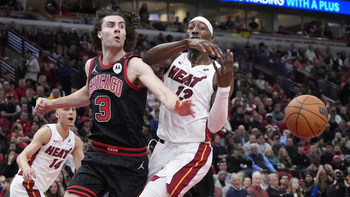 Chicago Bulls guard Josh Giddey (3) and Miami Heat center Bam Adebayo (13) go for the ball during the first quarter at United Center.