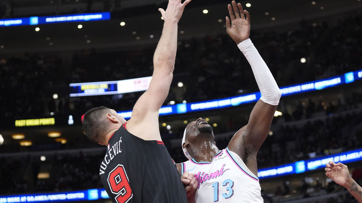 Chicago Bulls center Nikola Vucevic (9) defends Miami Heat center Bam Adebayo (13) during the second half at United Center.