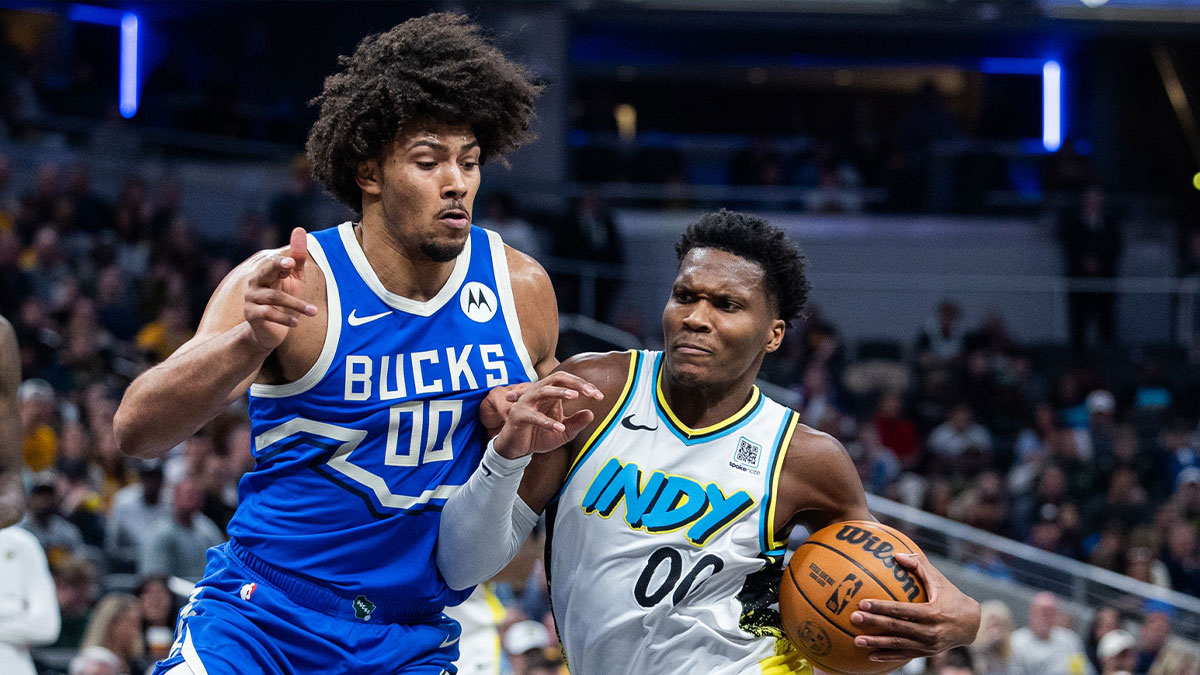 Indiana Pacers guard Bennedict Mathurin (00) dribbles the ball while Milwaukee Bucks center Jericho Sims (00) defends in the first half at Gainbridge Fieldhouse.