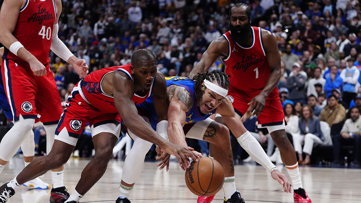 LA Clippers guard Kris Dunn (8) and Denver Nuggets forward Aaron Gordon (32) reach for a loose ball in the fourth quarter at Ball Arena.