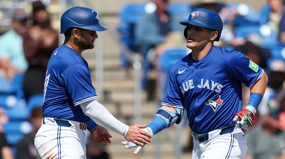 Toronto Blue Jays outfielder Daulton Varsho (5) celebrates with shortstop Bo Bichette (11) after hitting a two run home run against the Baltimore Orioles in the fifth inning during spring training at TD Ballpark.