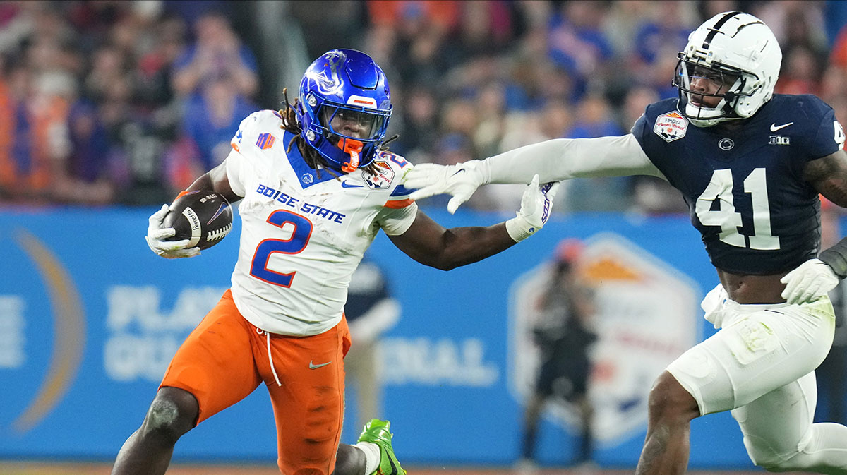 Boise State Broncos running back Ashton Jeanty (2) runs past Penn State Nittany Lions linebacker Kobe King (41) during their Vrbo Fiesta Bowl matchup at State Farm Stadium on Dec. 31, 2024.
