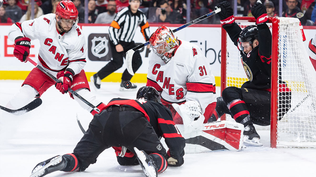 Ottawa Senators left wing Brady Tkachuk (7) end up in the net on a drive with the puck while Carolina Hurricanes goalie Frederik Andersen (31) makes the save in the first period at the Canadian Tire Centre.