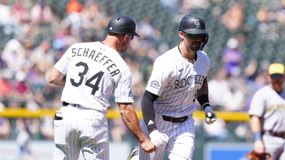 Colorado Rockies center fielder Brenton Doyle (9) celebrates his solo home run with third base coach Warren Schaeffer (34) in the first inning against the Milwaukee Brewers at Coors Field.