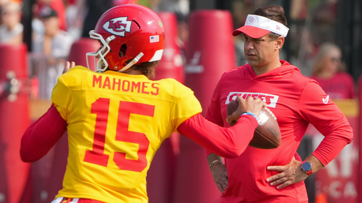 Kansas City Chiefs quarterback Patrick Mahomes (15) throws a pass as general manager Brett Veach watches in the background during training camp at Missouri Western State University