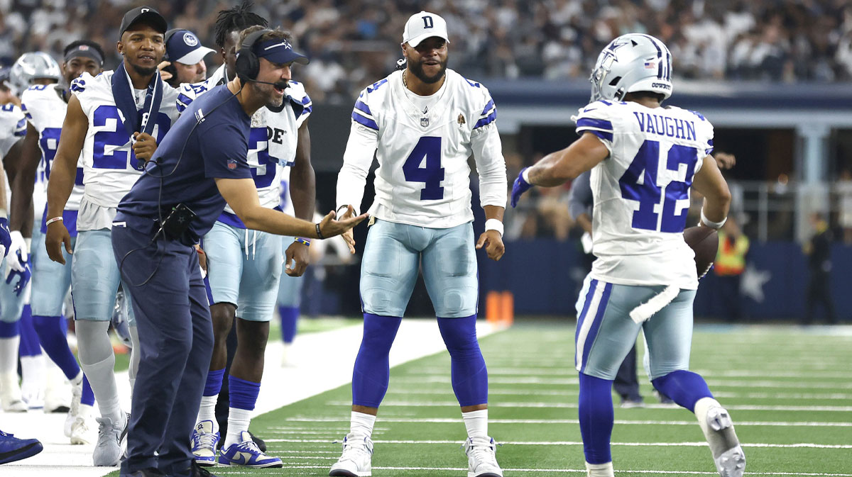 Dallas Cowboys offensive coordinator Brian Schottenheimer and quarterback Dak Prescott (4) and running back Deuce Vaughn (42) celebrate a touchdown in the fourth quarter against the Jacksonville Jaguars at AT&T Stadium.