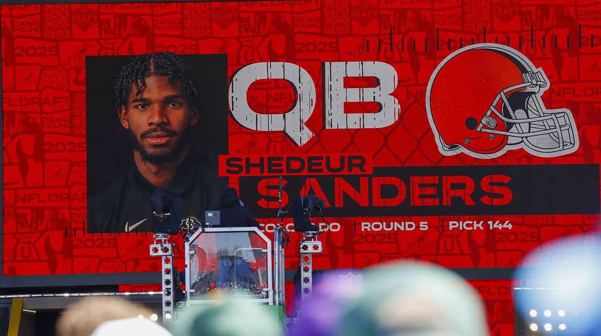 A graphic announcing Colorado quarterback Shedeur Sanders’ selection by the Cleveland Browns with the 144th overall pick is seen in the Draft Theater during the third day of the 2025 NFL Draft at Lambeau Field.