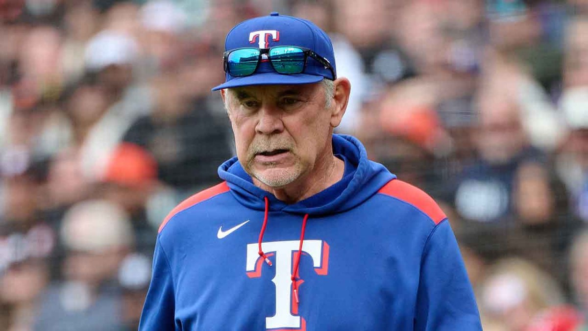 Texas Rangers manager Bruce Bochy (15) walks onto the field to check on an injured player against the San Francisco Giants during the eighth inning at Oracle Park.