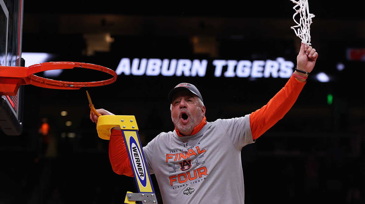 Auburn Tigers men's basketball head coach Bruce Pearl cuts down the net after winning the South Regional final of the 2025 NCAA tournament against the Michigan State Spartans at State Farm Arena.