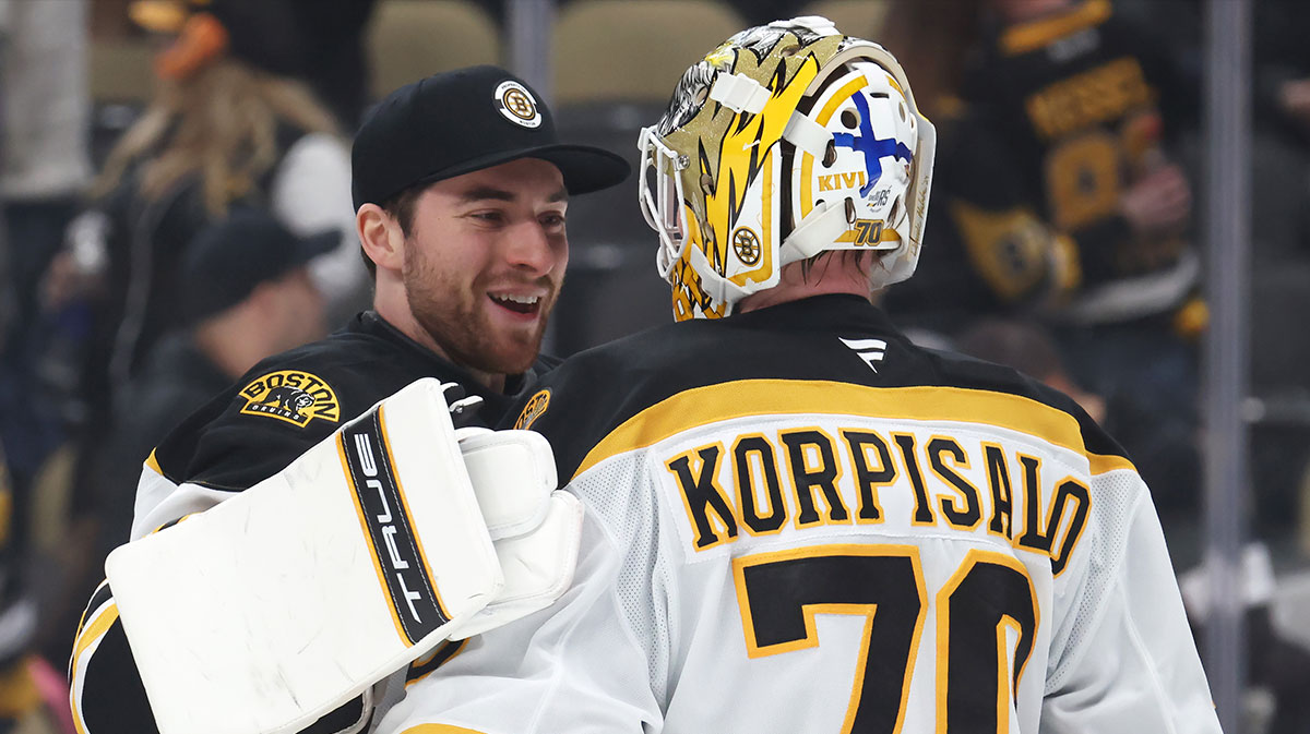 Boston Bruins goaltenders Jeremy Swayman (left) and Joonas Korpisalo (70) celebrate after defeating the Pittsburgh Penguins at PPG Paints Arena.