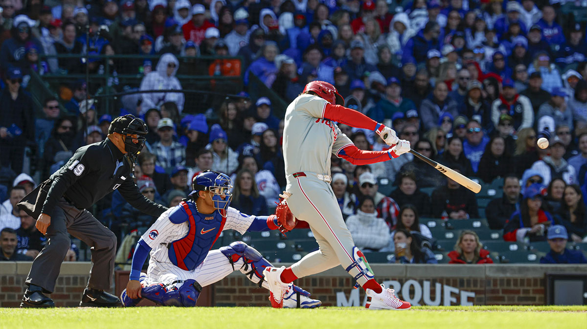 Philadelphia Phillies first baseman Bryce Harper (3) hits a two-run double against the Chicago Cubs during the fourth inning at Wrigley Field