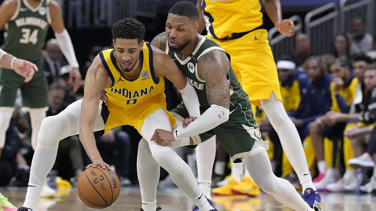 Bucks guard Damian Lillard (0) defends against Indiana Pacers guard Tyrese Haliburton (0)